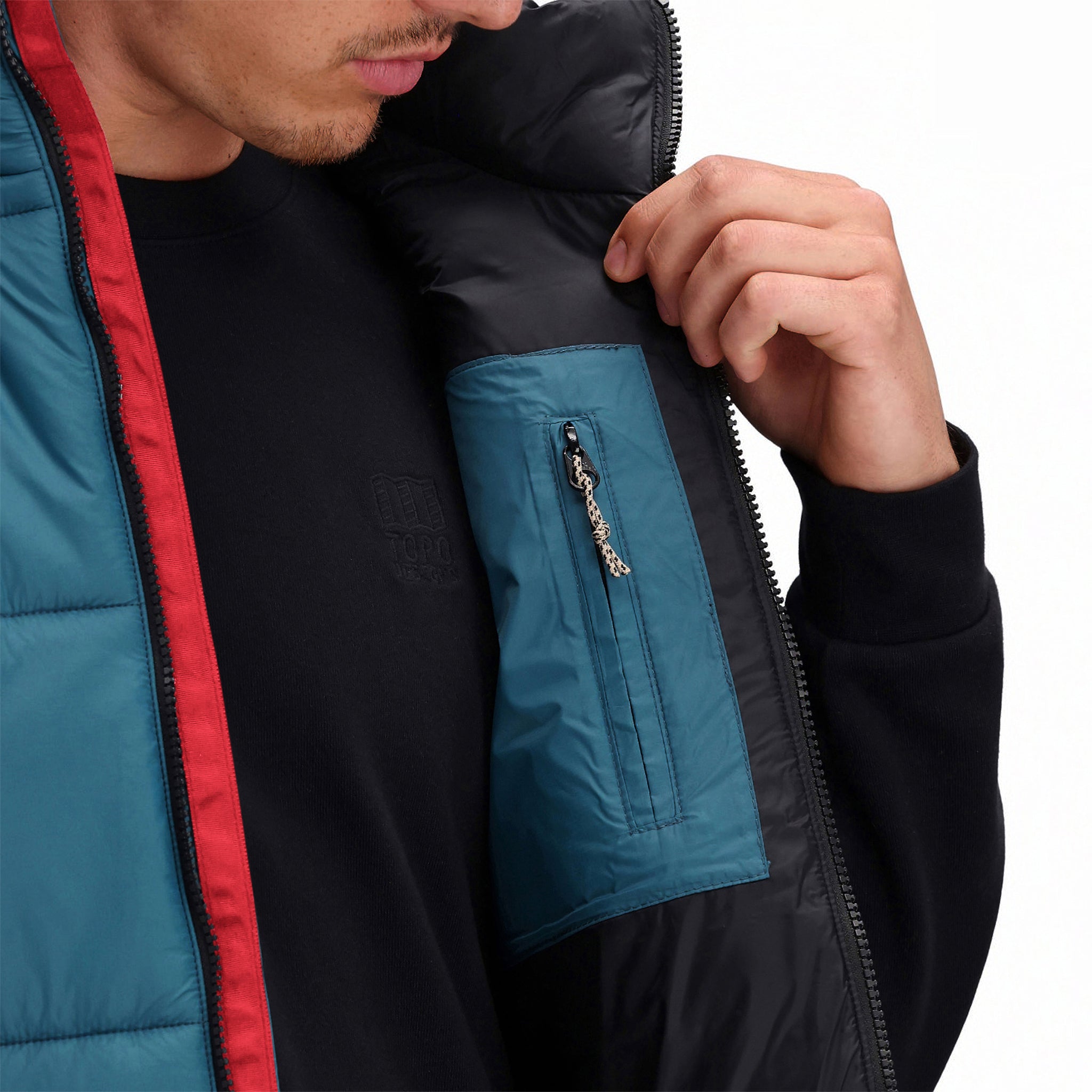 General front model shot of Topo Designs Men's Mountain Puffer recycled insulated Vest in "Pond Blue" showing interior chest pocket.