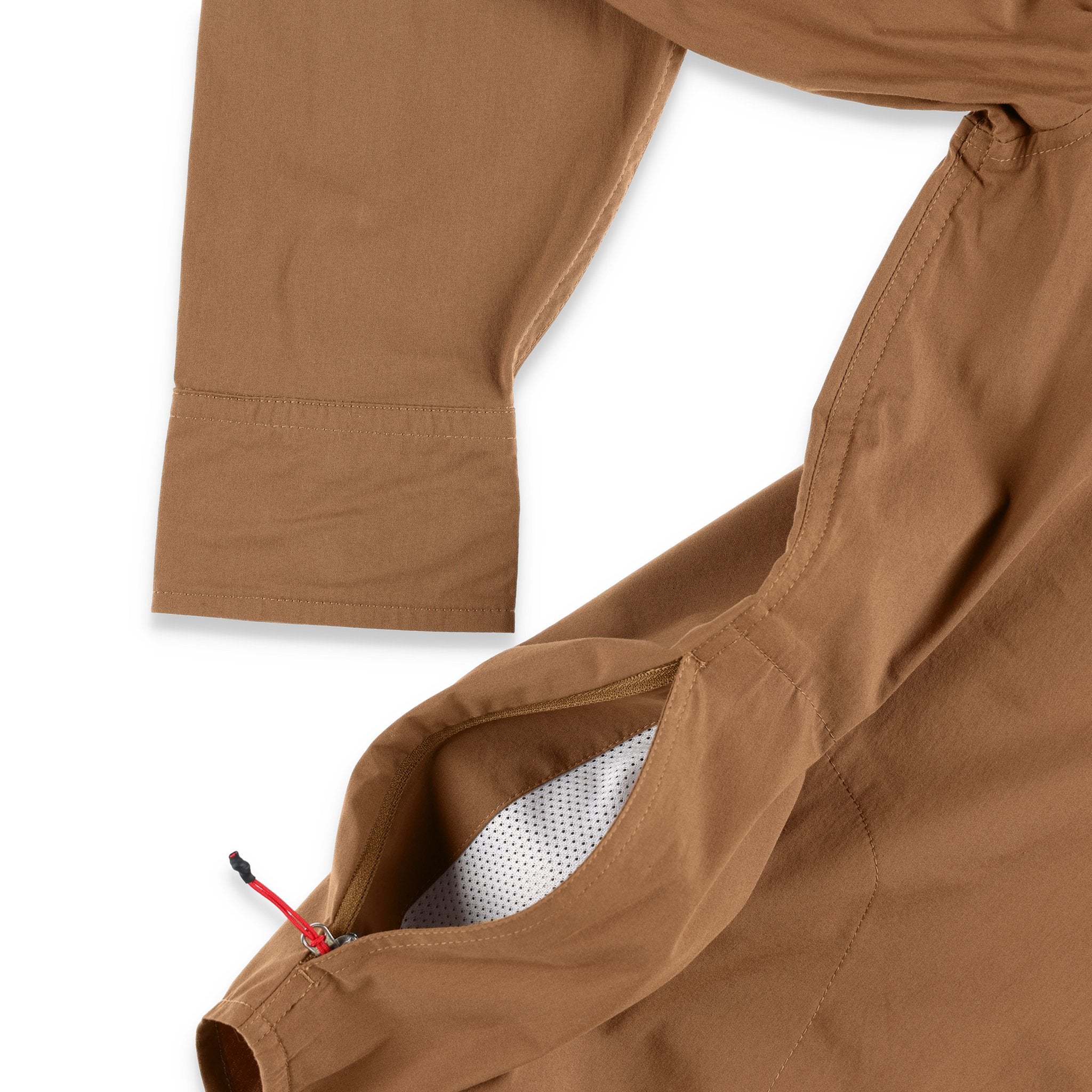 General shot of side zipper pockets on the Topo Designs Men's Global Shirt long sleeve lightweight travel snap shirt in dark khaki brown.