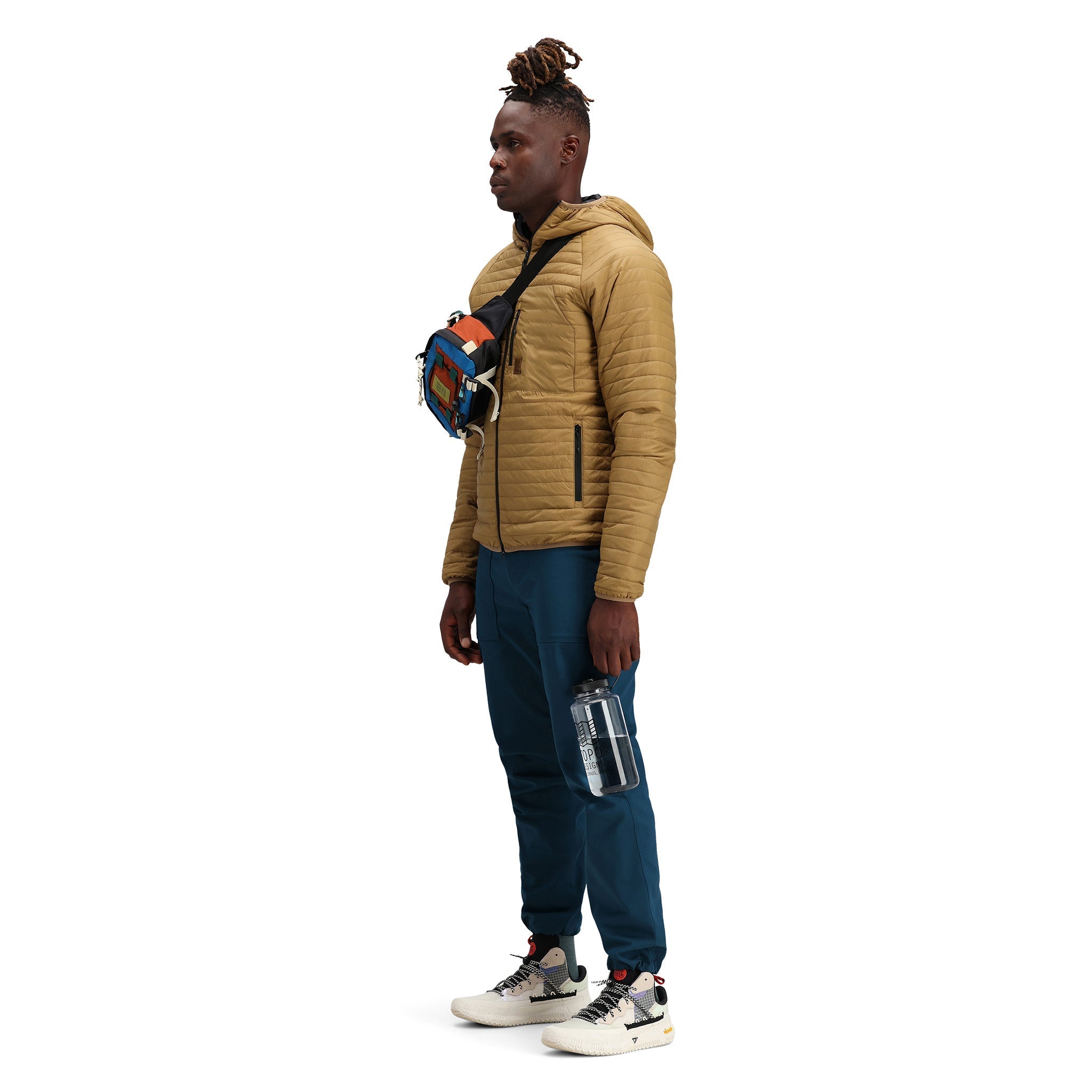 Front model shot of Topo Designs Men's Global Puffer packable recycled insulated Hoodie jacket in "dark khaki" brown