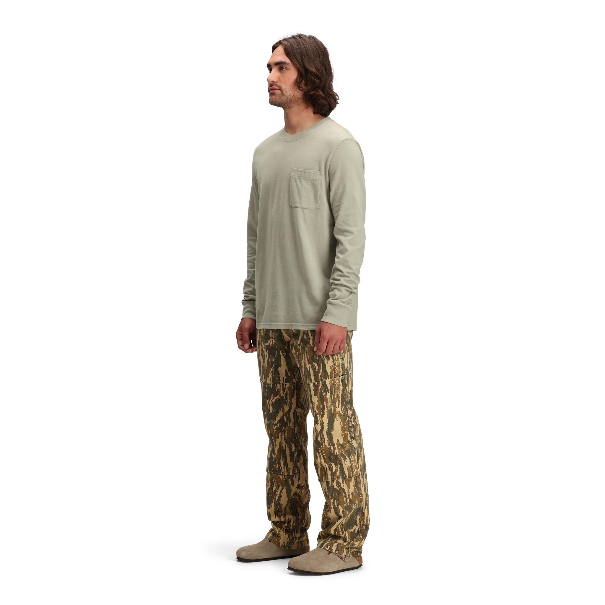 General side model shot of Topo Designs Dirt Utility Pants - Men's  in "Dirt Camo Print"