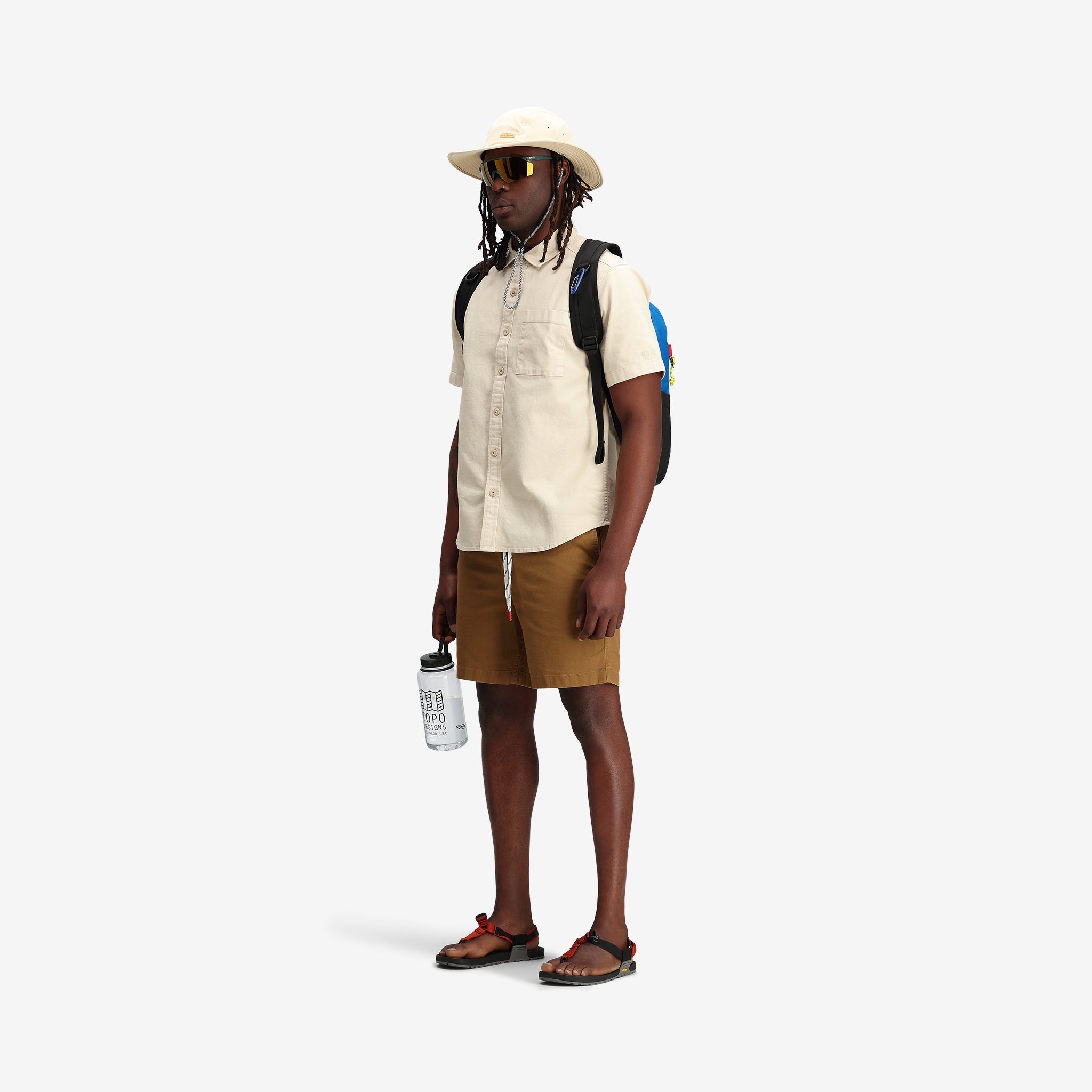 Topo Designs Men's Short Sleeve Dirt Shirt in "Sand" white natural on model.