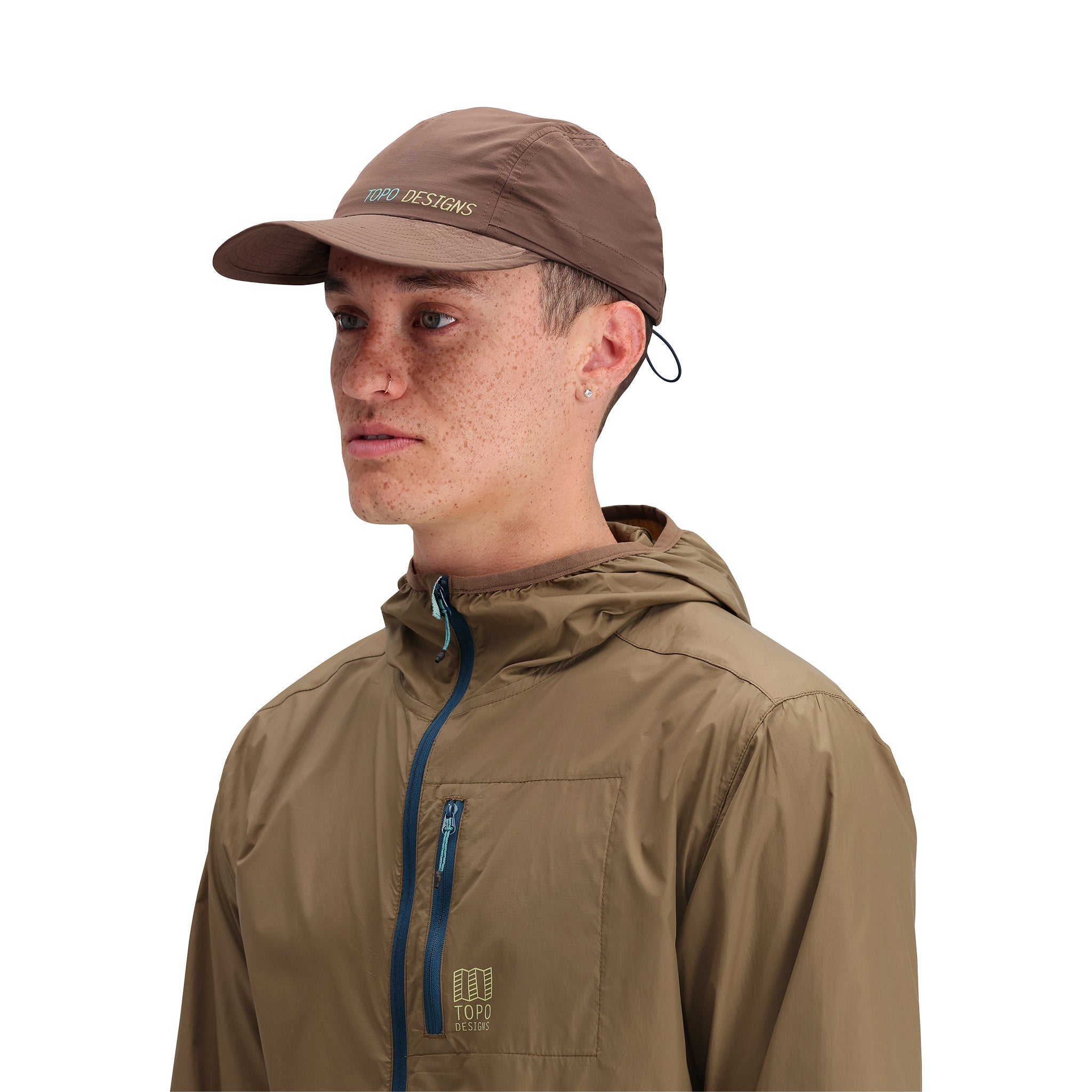 General side model shot of Topo Designs Global Packable Hat in "Desert Palm"