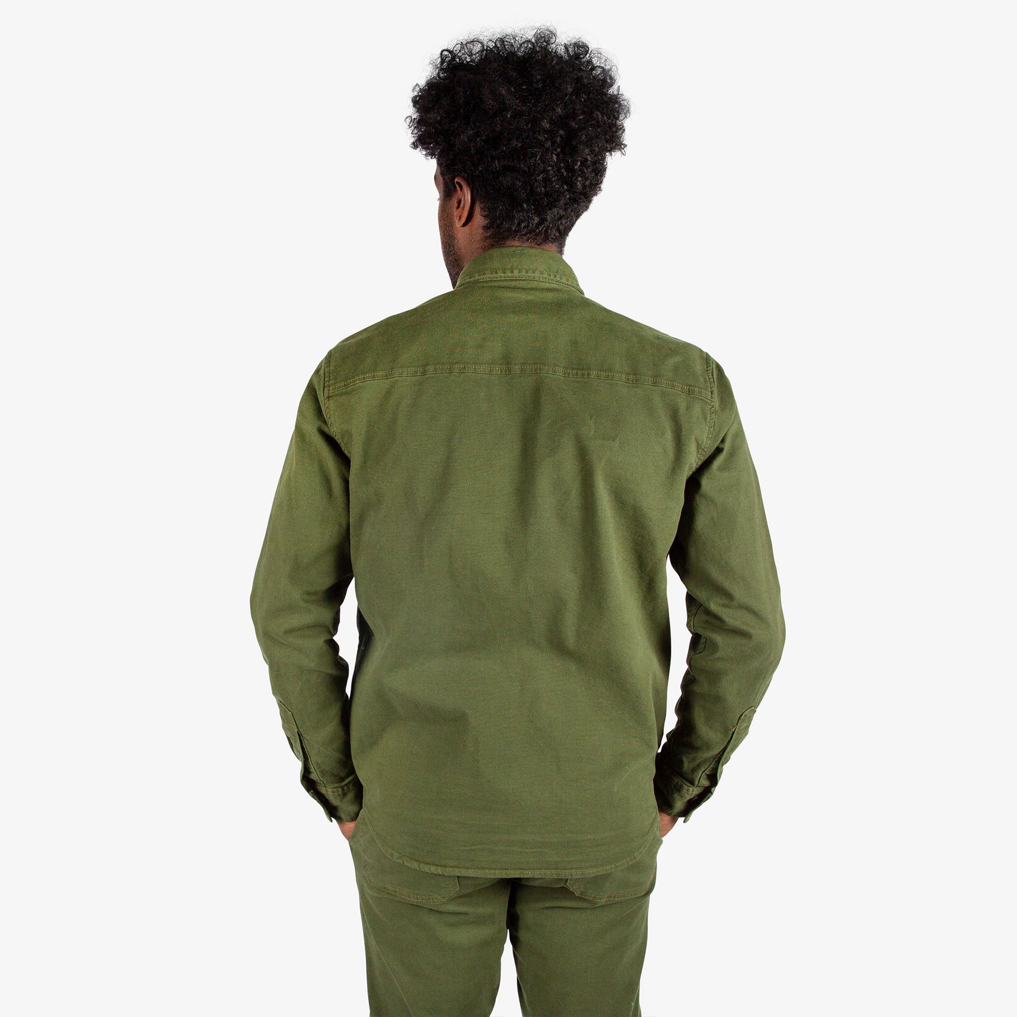 Close-up back model shot of Topo Designs Men's Dirt Shirt & Pants in "Olive".