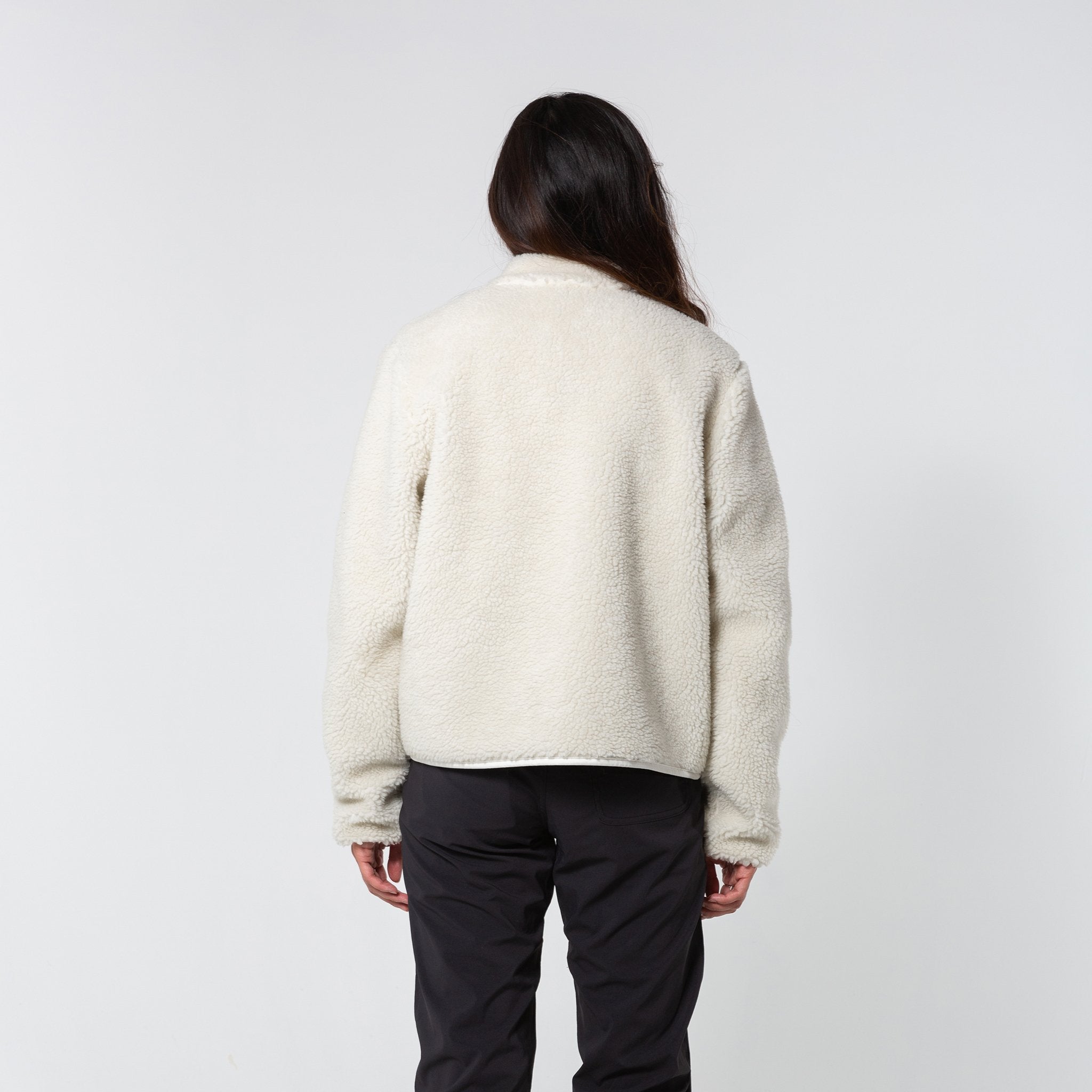 Back model shot of the sherpa jacket in "natural / khaki" showing the sherpa fleece zipped