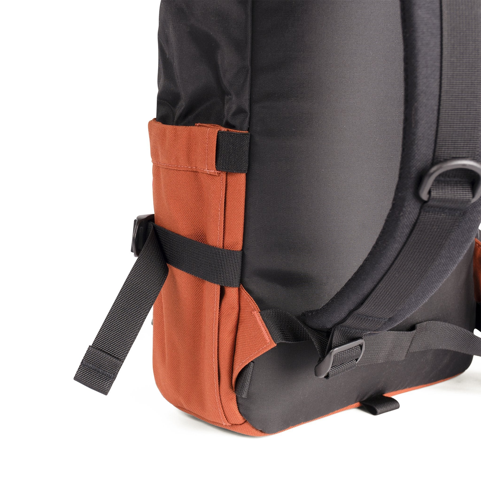 3/4 Back Detail Shot of the Topo Designs Rover Pack Classic in Black/Clay showing collapsible water bottle pockets on side