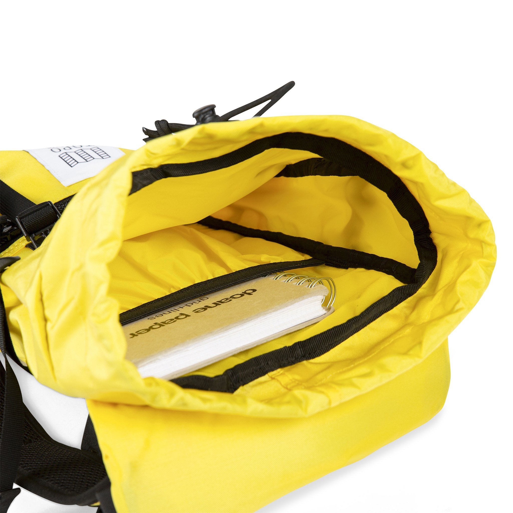 Interior detail shot of the Topo Designs Rover Pack Mini in Yellow showing notebook or tablet sleeve