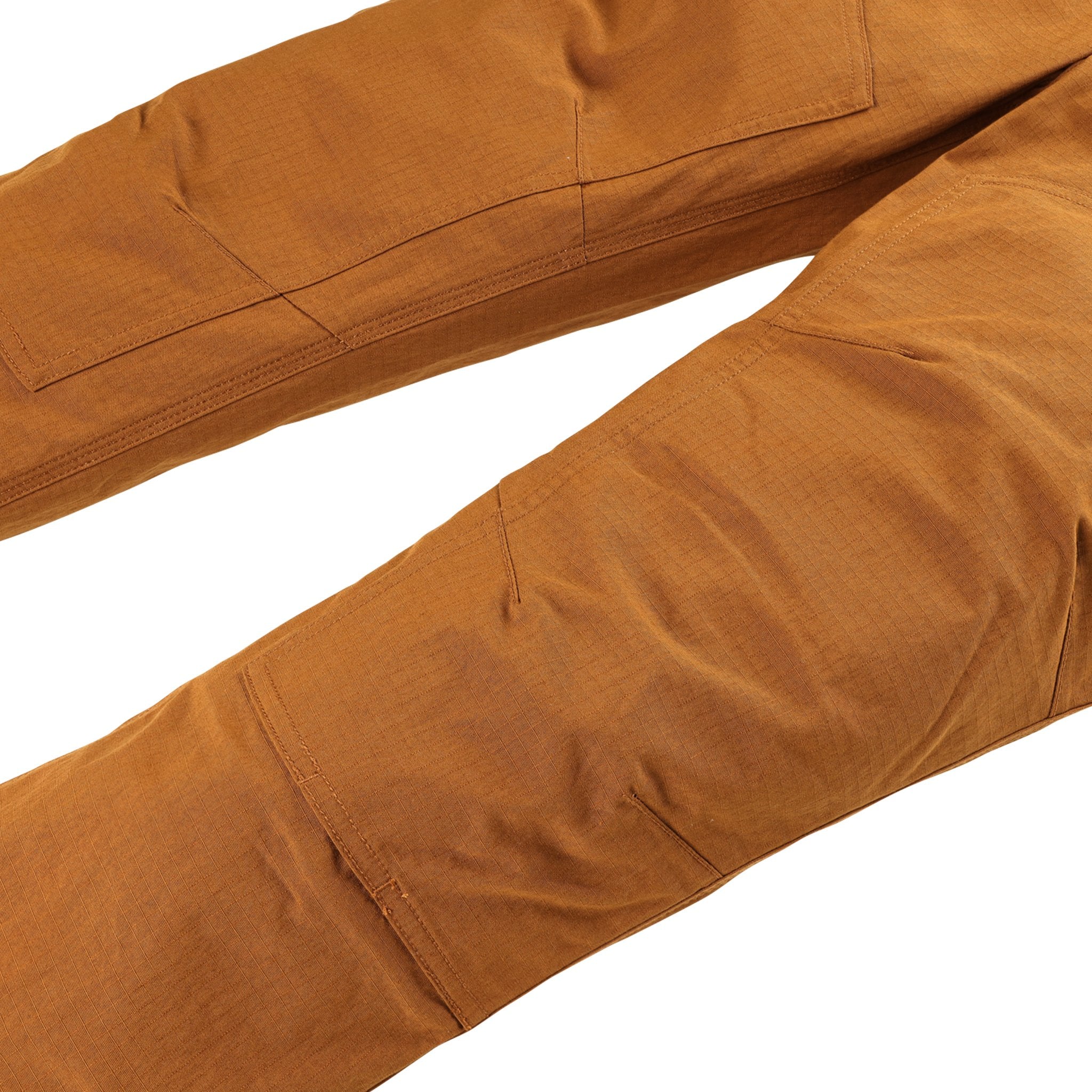 General shot of reinforced knees on Topo Designs Men's Mountain lightweight hiking Pants Ripstop in Earth brown.