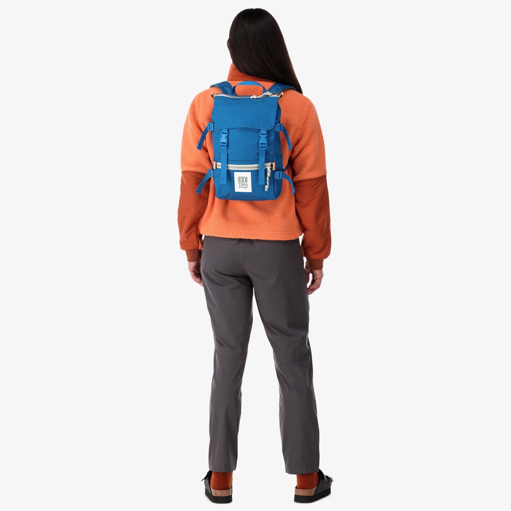 Topo Designs Rover Pack Mini in blue canvas on model's back.