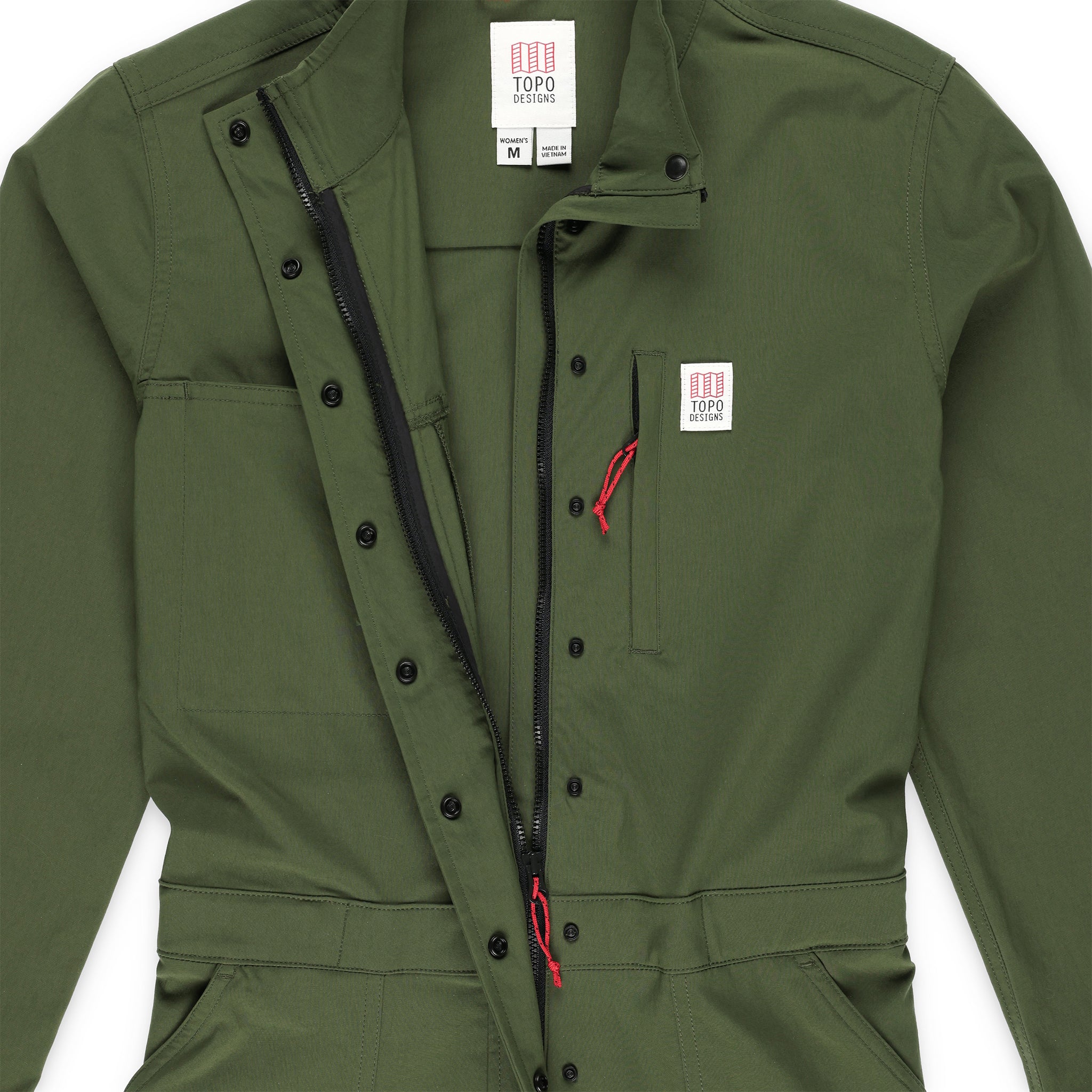 Detail shot of the Topo Designs Women's Coverall in olive green showing collar, front zipper, and snaps open.