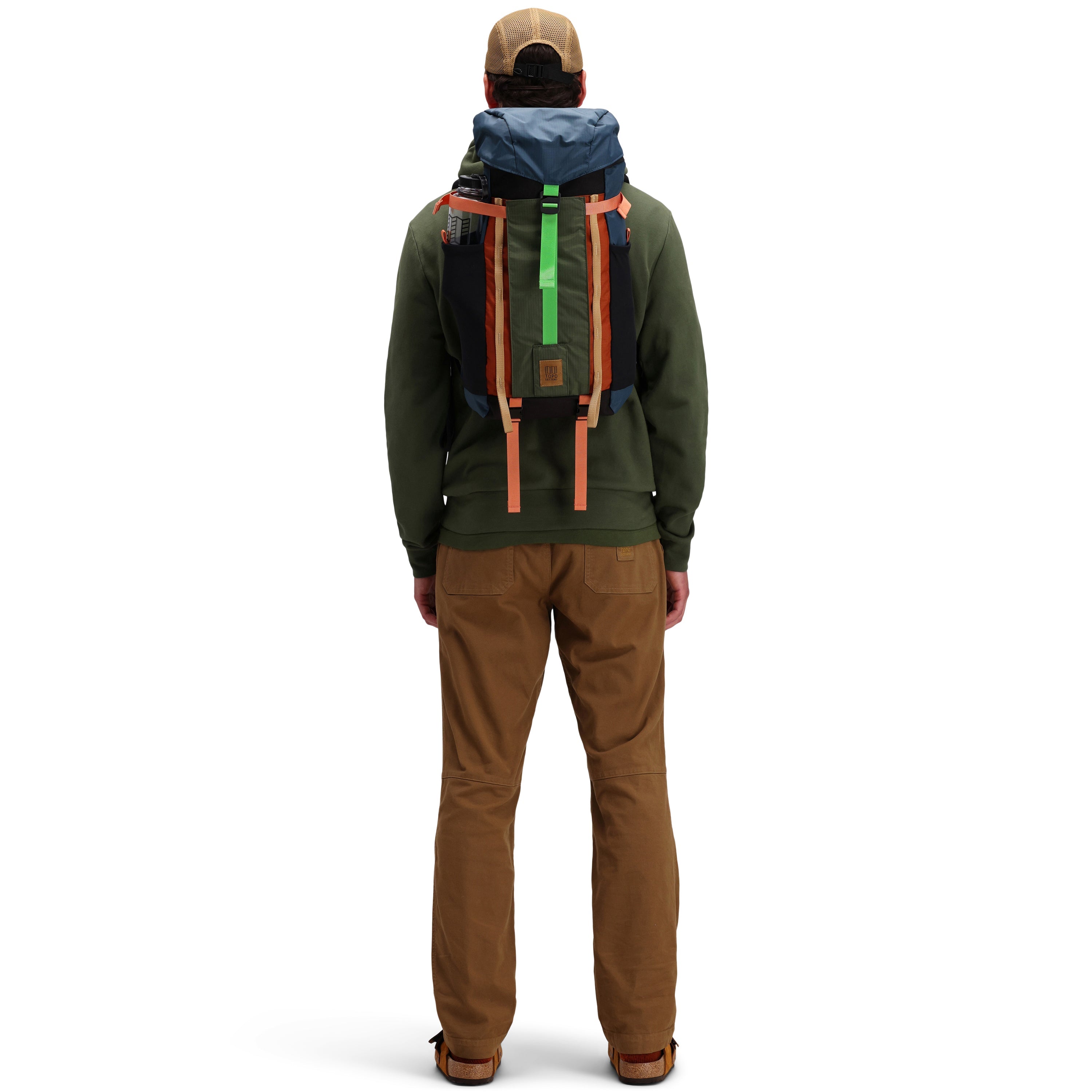 Back model shot of Topo Designs Men's Dirt Pants 100% organic cotton drawstring waist in "Dark Khaki" brown.