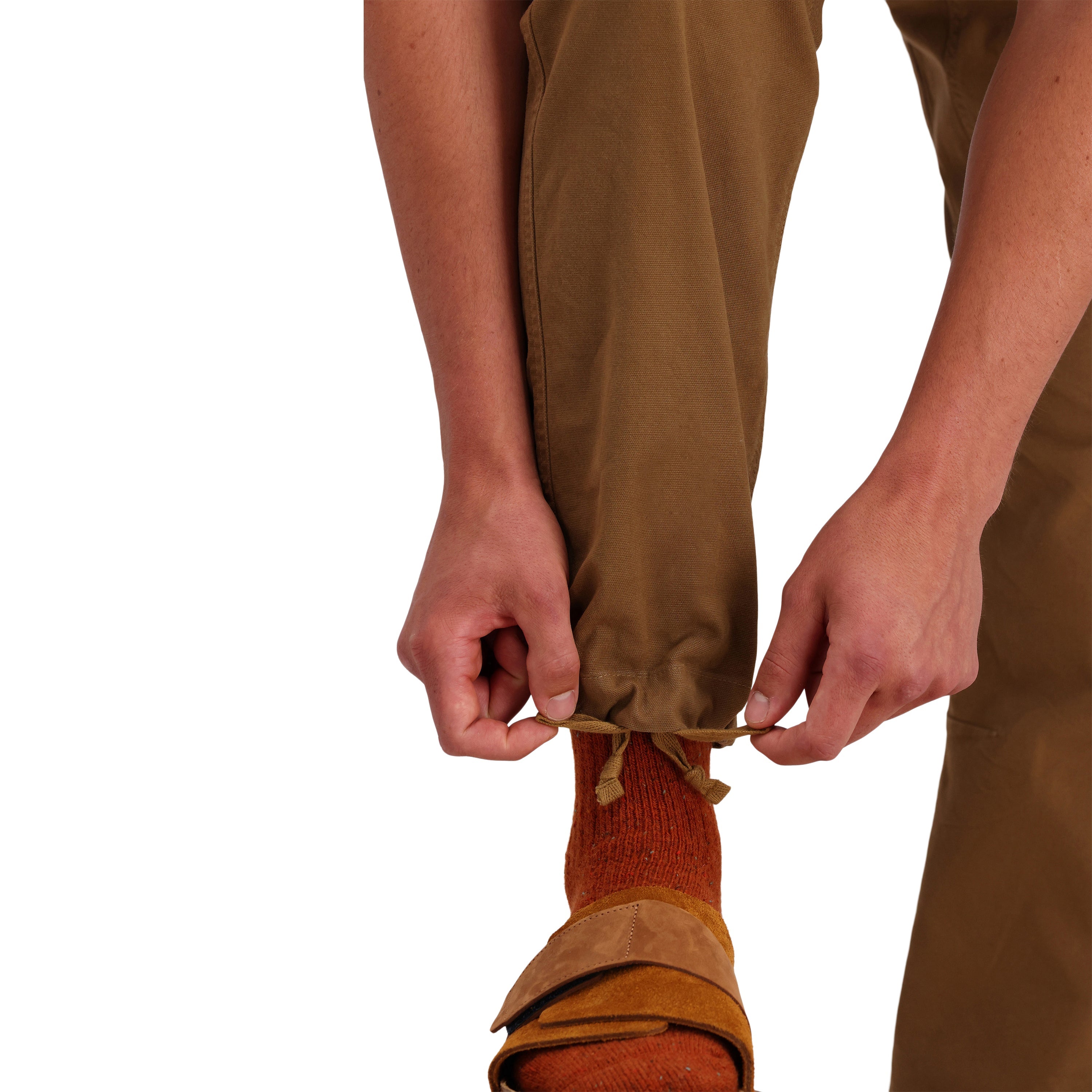 Front model shot of Topo Designs Men's Dirt Pants 100% organic cotton drawstring waist in "Dark Khaki" brown.