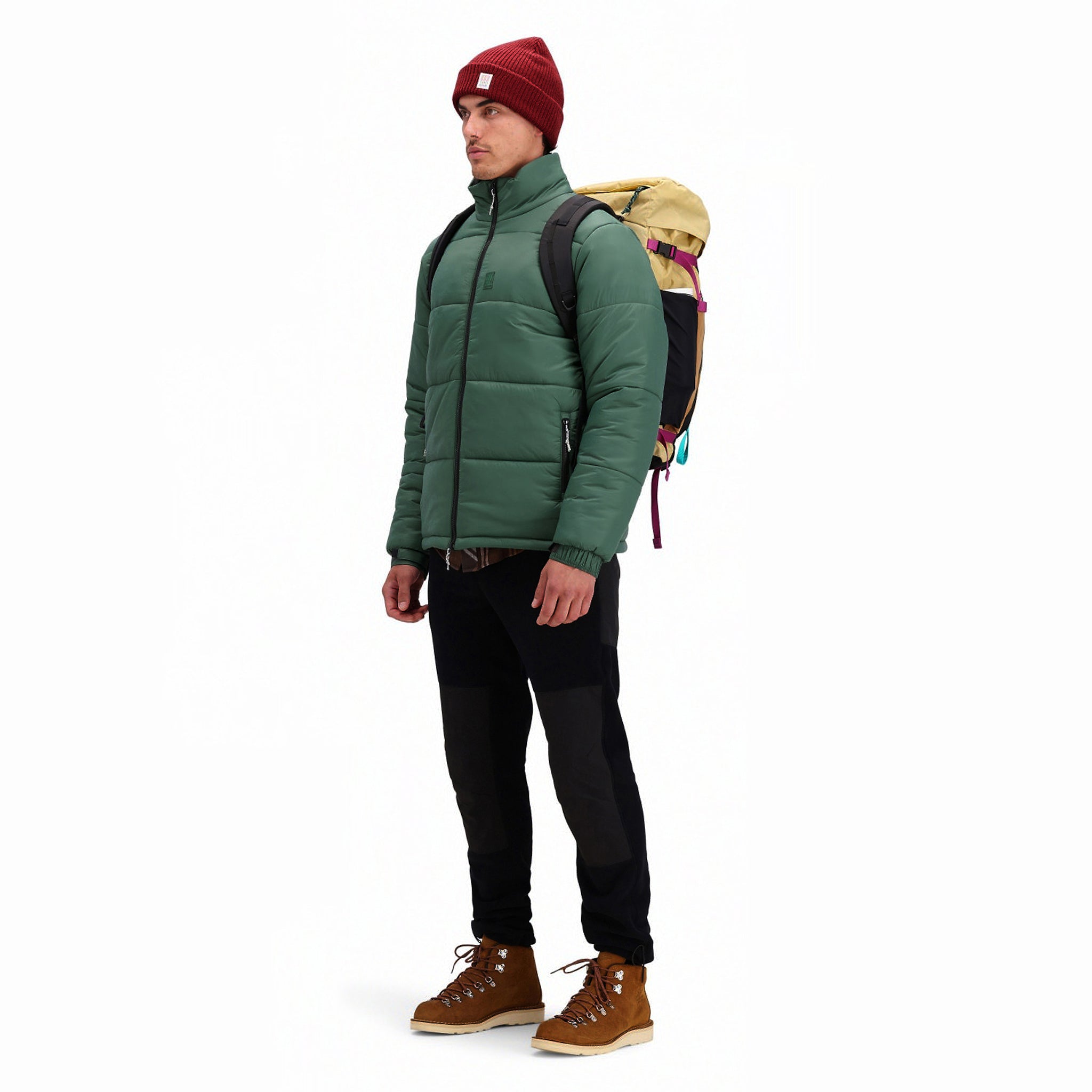 Front model shot of Topo Designs Men's Puffer recycled insulated Jacket in "Forest" green.