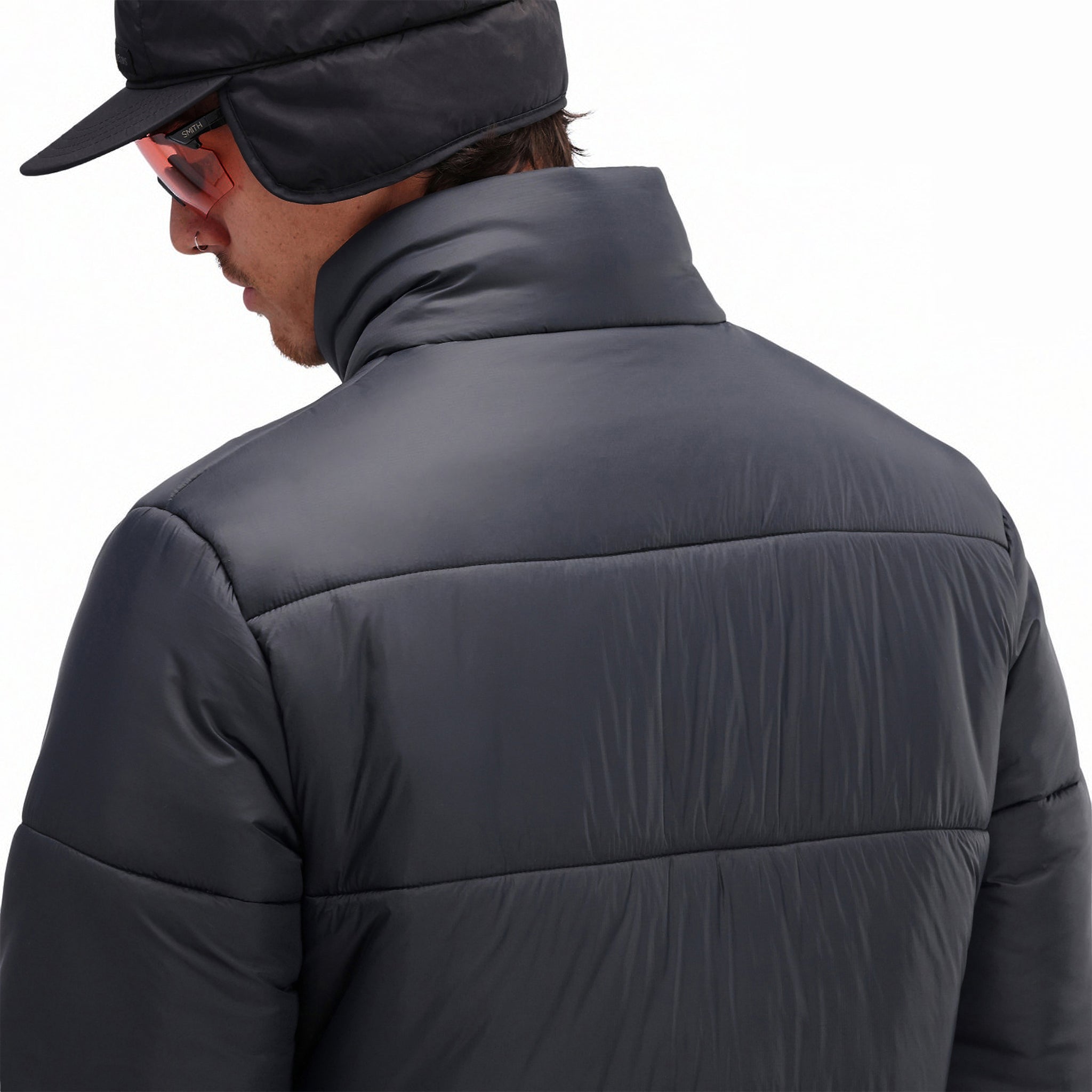 General back model detail shot of baffles on Topo Designs Men's Puffer recycled insulated Jacket in "Black"