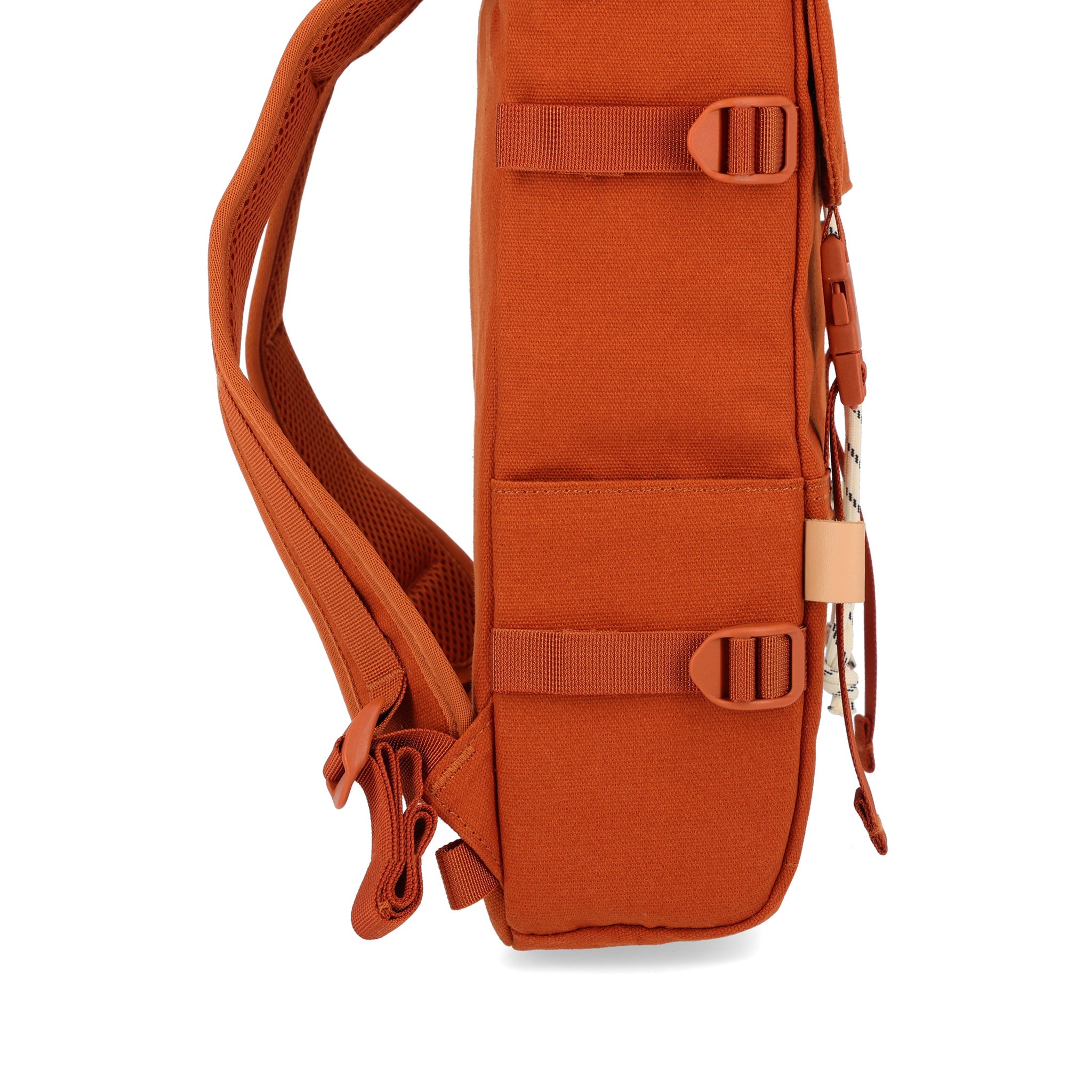 Side slip pockets on Topo Designs Rover Pack Mini Backpack in Clay Canvas.