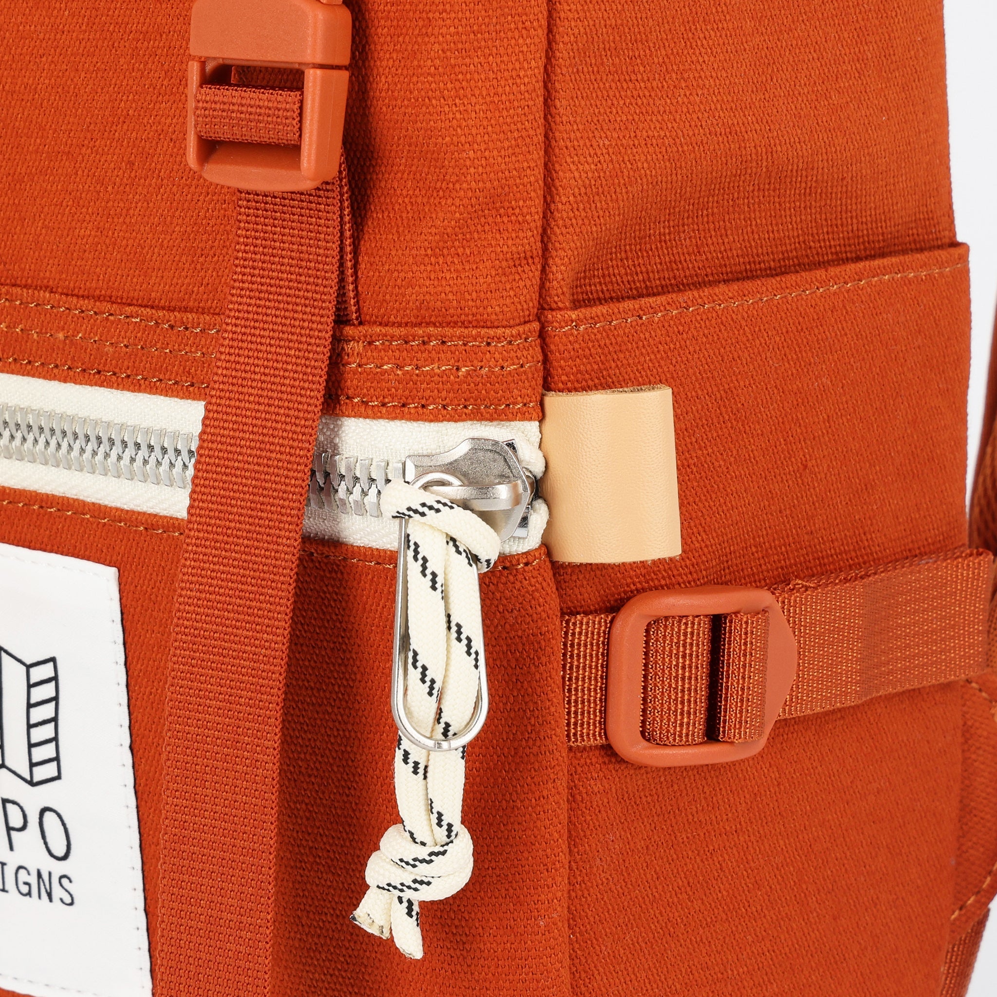 Zipper pulls on Topo Designs Rover Pack Mini Backpack in Clay Canvas.