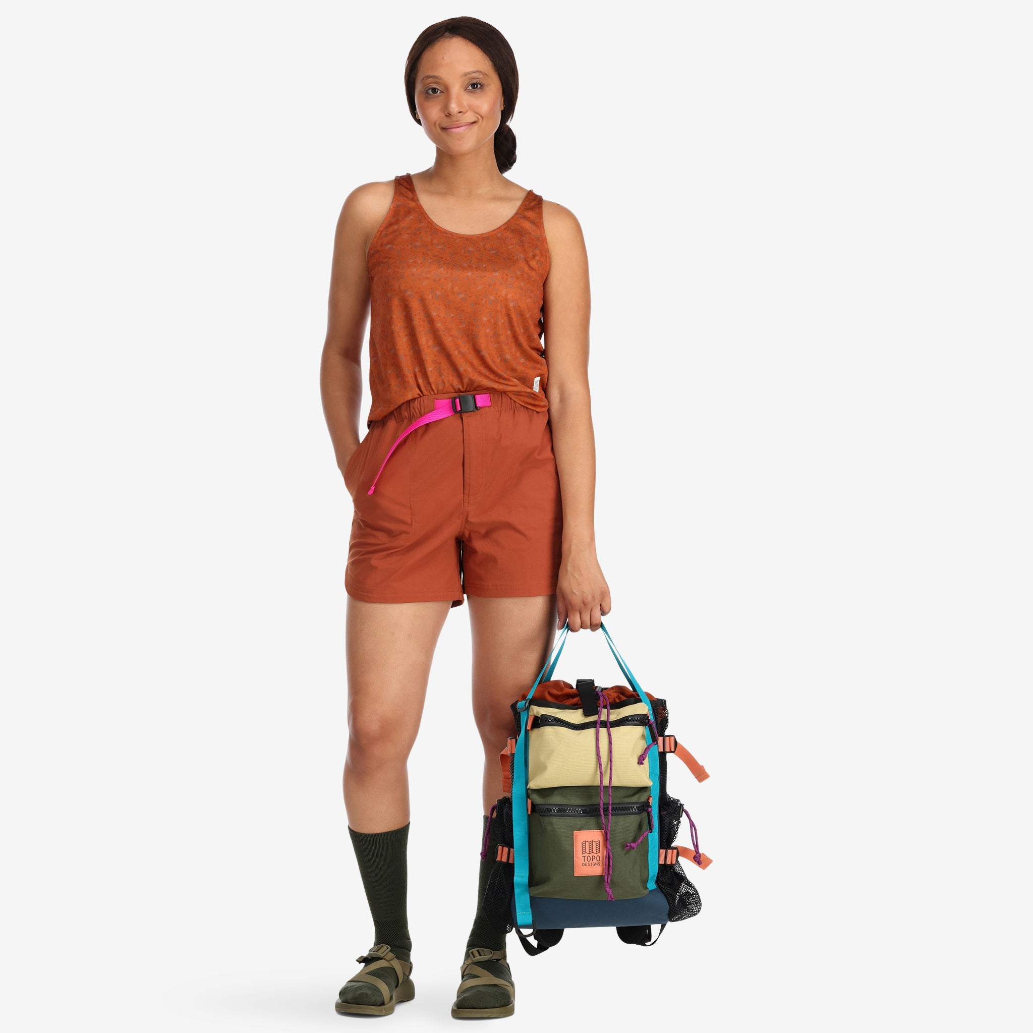 General shot of Topo Designs Women's 30+ UPF moisture wicking River Tank top in clay orange terrazzo print on model.