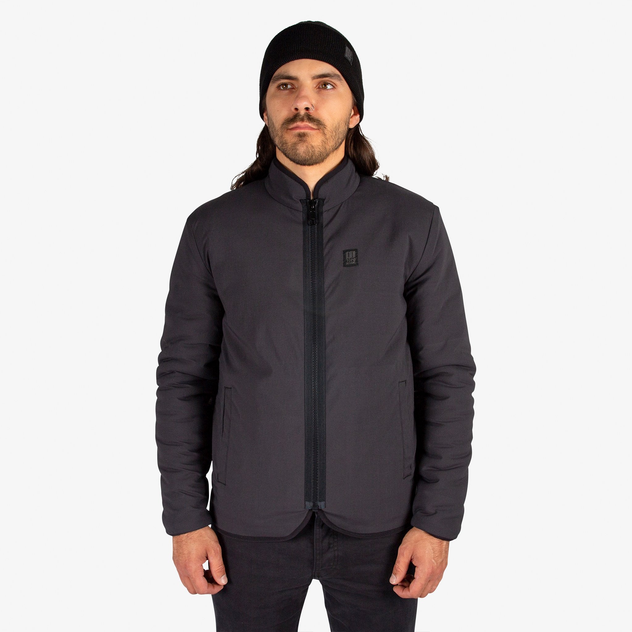 General close-up front model shot of Topo Designs Men's Sherpa Jacket in Black showing DWR side.