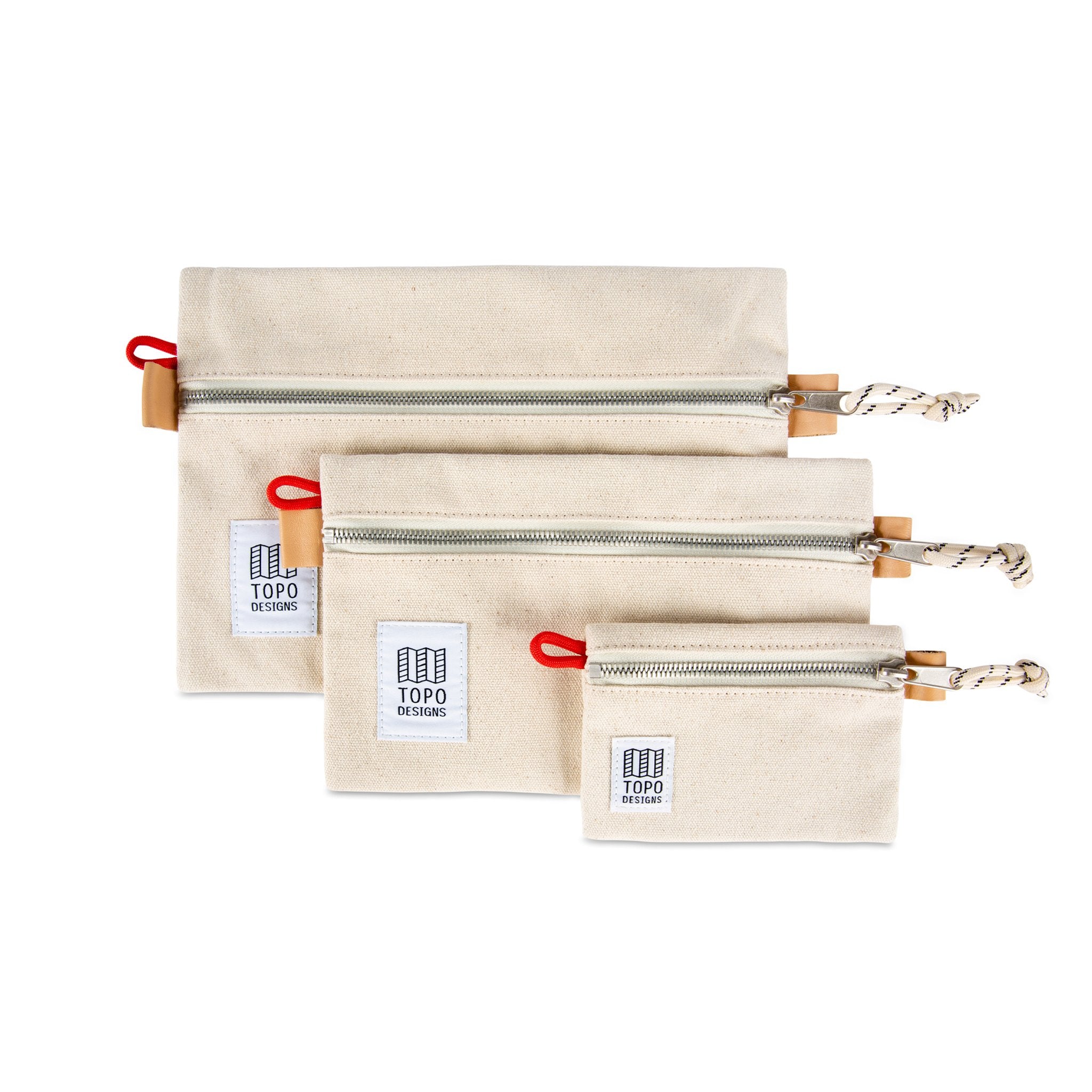 Collection of 3 sizes of Topo Designs Accessory Bags in Natural white canvas.