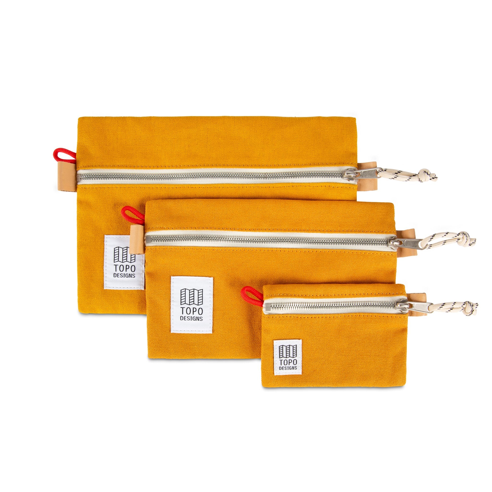 Collection of 3 sizes of Topo Designs Accessory Bags in Mustard yellow canvas.